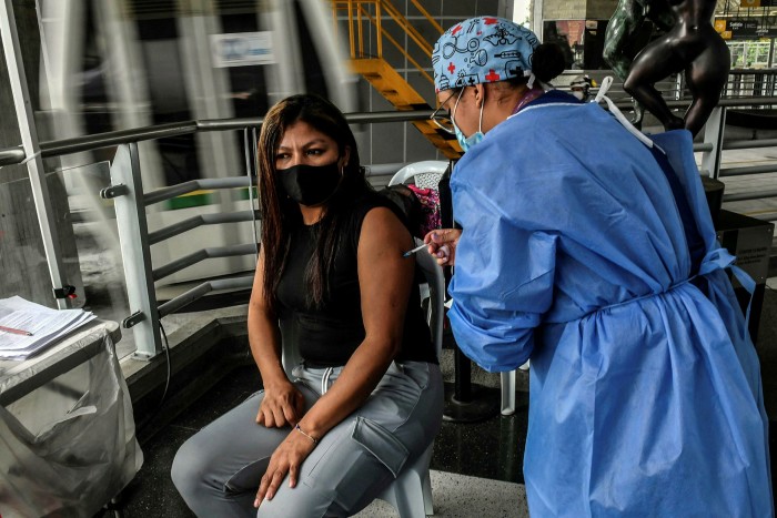 Una mujer en Medellín, Colombia recibe la vacuna CoronaVac, desarrollada por la china Sinovac