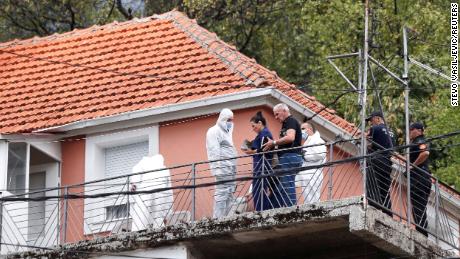La fiscal estatal Andrijana Nastic habla con el equipo forense en la casa donde un hombre armado inició un tiroteo masivo en Cetinje, Montenegro, el 12 de agosto de 2022.