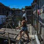 Una mujer camina por la favela Coelho