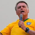 Jair Bolsonaro speaking into a microphone