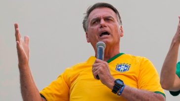 Jair Bolsonaro speaking into a microphone