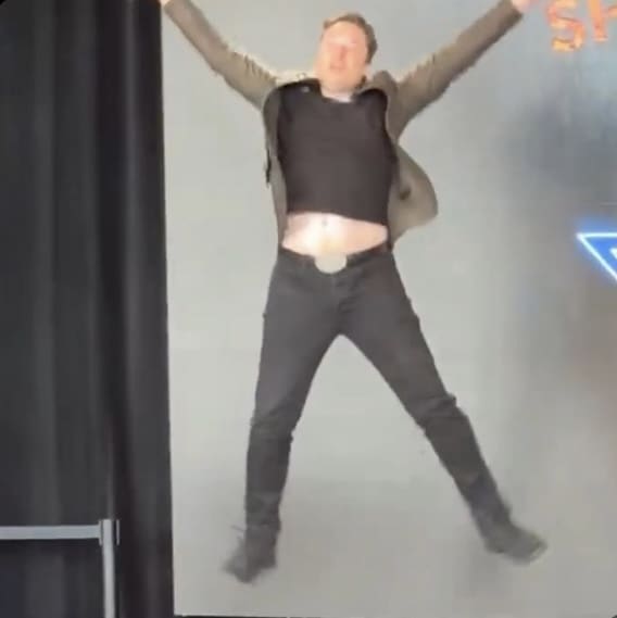 Elon Musk jumping up and making an X with his body