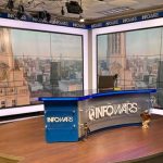 The Infowars set, featuring a large desk with the Infowars logo prominently displayed.