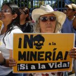 A woman holds up a sign in Spanish that translates to ‘No to mining, yes to life’, during a protest agains the mining bill San Salvador, El Salvador