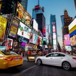 Cars drive near Time Square in New York