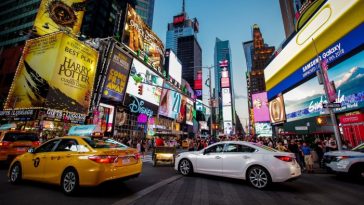 Cars drive near Time Square in New York