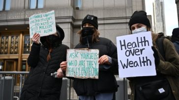 Los manifestantes sostienen carteles frente al tribunal federal de Manhattan, donde se espera que Mangione haga su aparición inicial el jueves.