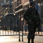 A member of US military stands on Dauphine street, Thursday in New Orleans.