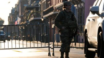 A member of US military stands on Dauphine street, Thursday in New Orleans.