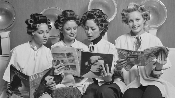 Four women sit in a hair salon in the 1970s