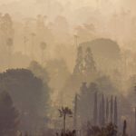 Smoke over destroyed homes in the aftermath of the Eaton Fire in Altadena, California