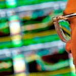 A trader works at his desk on the floor of the New York Stock Exchange