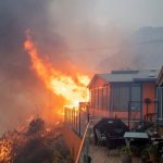 Fire burns near homes