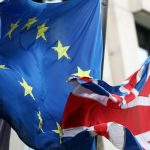 An EU flag flies between two British flags