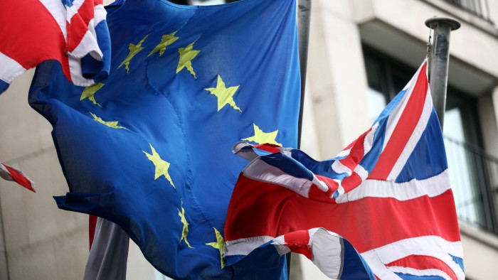 An EU flag flies between two British flags