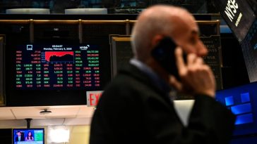 Traders work on the floor of the New York Stock Exchange