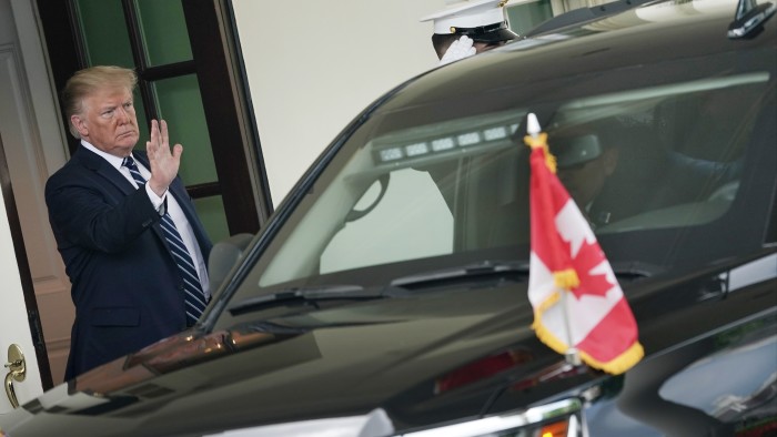 U.S. President Donald Trump waves as Canadian Prime Minister Justin Trudeau’s vehicle leaves following a visit at the White House June 20, 2019