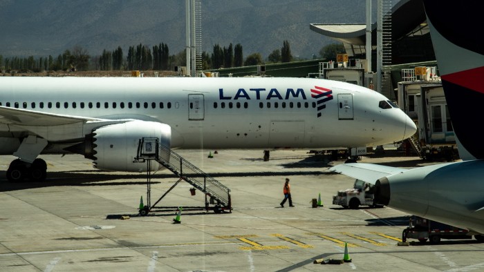 A Latam Airlines aircraft is parked on the tarmac at Arturo Merino Benitez International Airport in Santiago, Chile