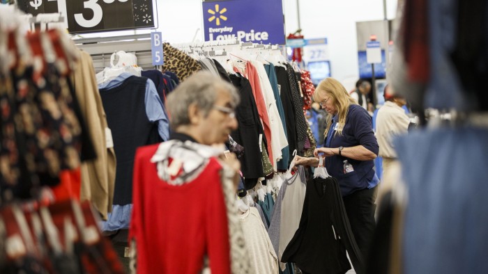 An employee arranges clothing at a Walmart stores in Burbank, California